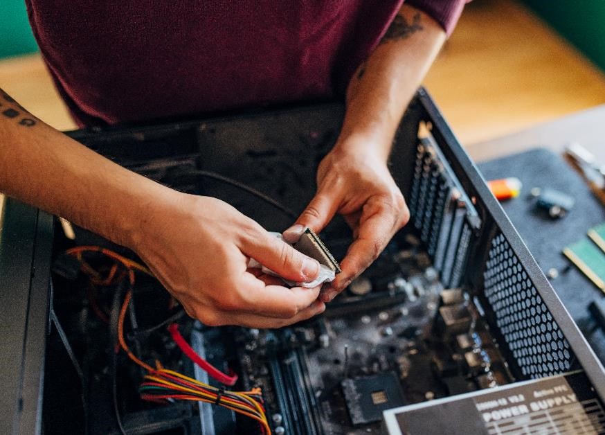 Asset recovery: a technician removing a processor from a PC for reuse